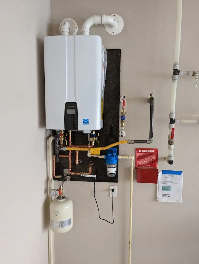 Professional plumber installing copper piping in a Fort Riley home